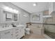 Bright bathroom featuring double sink vanity, soaking tub, and glass shower at 6606 Dolphin Cove Dr, Apollo Beach, FL 33572
