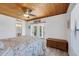 Bedroom with wood-paneled ceiling, light-toned wood flooring, and french door access to outdoor space at 6606 Dolphin Cove Dr, Apollo Beach, FL 33572