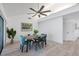 Bright dining room with modern fan, dining table set, and light plank flooring for a modern look at 6606 Dolphin Cove Dr, Apollo Beach, FL 33572