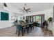 Bright dining room with modern fan, dining table set, and sliding doors that lead to a screened patio and pool at 6606 Dolphin Cove Dr, Apollo Beach, FL 33572