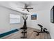 Home exercise room with ceiling fan, window, and Bowflex machine at 6606 Dolphin Cove Dr, Apollo Beach, FL 33572