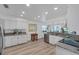 Bright kitchen features white cabinetry, granite countertops, stainless appliances, and plank flooring throughout at 6606 Dolphin Cove Dr, Apollo Beach, FL 33572