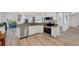 Bright kitchen features white cabinetry, granite countertops, stainless appliances, and open view to other living areas at 6606 Dolphin Cove Dr, Apollo Beach, FL 33572