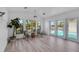 Open living area with a ceiling fan, beachy decor, and views of the pool and lanai at 6606 Dolphin Cove Dr, Apollo Beach, FL 33572