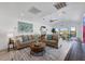 Bright living room features a fireplace, wood beam mantle, neutral decor, and plank flooring throughout the home at 6606 Dolphin Cove Dr, Apollo Beach, FL 33572