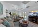 Bright living room features fireplace, neutral decor, plank flooring, and sliding glass doors to the outdoor living area at 6606 Dolphin Cove Dr, Apollo Beach, FL 33572