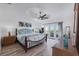 Main bedroom with tray ceiling, ceiling fan, and balcony access at 6606 Dolphin Cove Dr, Apollo Beach, FL 33572