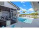 Inviting backyard pool with adjacent screened porch and spacious deck, perfect for outdoor entertaining and relaxation at 6606 Dolphin Cove Dr, Apollo Beach, FL 33572