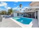 Backyard view showcases the sparkling pool, patio, and enclosed porch, perfect for outdoor entertaining at 6606 Dolphin Cove Dr, Apollo Beach, FL 33572