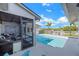 Sparkling swimming pool and outdoor deck with screened lanai, perfect for relaxing outdoors at 6606 Dolphin Cove Dr, Apollo Beach, FL 33572