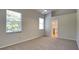 Light-filled bedroom with neutral walls, carpet and ensuite bathroom at 6805 Winslow St, Sarasota, FL 34243
