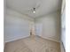 Carpeted bedroom features a ceiling fan and a double-door closet at 6805 Winslow St, Sarasota, FL 34243