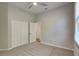 Neutral carpeted bedroom with ceiling fan, closet, and bright natural light at 6805 Winslow St, Sarasota, FL 34243