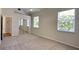 Spacious bedroom with carpet, ceiling fan, and natural light from windows at 6805 Winslow St, Sarasota, FL 34243