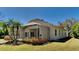 Rear exterior view of home featuring a screened-in patio and lush landscaping at 6805 Winslow St, Sarasota, FL 34243