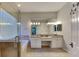 Bathroom with dual sinks, granite counters, soaking tub, and walk-in shower at 6805 Winslow St, Sarasota, FL 34243