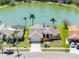 The property is located on a serene lake with lush landscaping at 8640 Chadwick Dr, Tampa, FL 33635