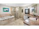 Beautiful bathroom featuring a standalone tub, glass shower, and dual sink vanity at 8640 Chadwick Dr, Tampa, FL 33635