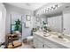 Light-filled bathroom featuring a large mirror, plants, and decorative touches at 8640 Chadwick Dr, Tampa, FL 33635