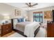 Comfortable bedroom featuring a ceiling fan, lake view, and wood floors at 8640 Chadwick Dr, Tampa, FL 33635