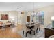 Open-concept dining room with modern chandelier and ample seating at 8640 Chadwick Dr, Tampa, FL 33635