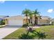 Charming single-story home featuring a well-manicured lawn and a two-car garage at 8640 Chadwick Dr, Tampa, FL 33635