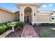 Inviting front entrance with a brick pathway, decorative plants, and a covered porch at 8640 Chadwick Dr, Tampa, FL 33635