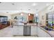 Open kitchen overlooking living area featuring stainless appliances, breakfast bar, and tile floors at 8640 Chadwick Dr, Tampa, FL 33635