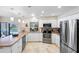 Well-lit kitchen offers stainless steel appliances and a breakfast bar overlooking the backyard at 8640 Chadwick Dr, Tampa, FL 33635