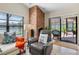 Inviting living room featuring a brick fireplace, seating, and screened-in lanai at 8640 Chadwick Dr, Tampa, FL 33635