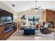 Comfortable living room with a fireplace and TV overlooking the lake at 8640 Chadwick Dr, Tampa, FL 33635