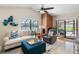 Comfortable living room with a brick fireplace, ceiling fan and screened-in lanai at 8640 Chadwick Dr, Tampa, FL 33635