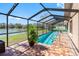The screened-in pool with brick patio is perfect for outdoor living at 8640 Chadwick Dr, Tampa, FL 33635