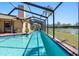 A beautiful screened-in pool with a view of the lake at 8640 Chadwick Dr, Tampa, FL 33635