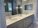 Bathroom featuring a large mirror, double sinks, and ample counter space at 953 Crosswind Ave, Sarasota, FL 34240