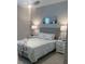 Cozy bedroom with grey walls, neutral bedding, ceiling fan, and matching nightstands at 953 Crosswind Ave, Sarasota, FL 34240