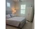 Well-lit bedroom with large windows and a neutral color scheme at 953 Crosswind Ave, Sarasota, FL 34240