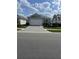 Charming single-story home with a two-car garage, manicured lawn, and a paved driveway at 953 Crosswind Ave, Sarasota, FL 34240