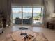 Bright living room with an attractive lake view beyond the patio doors, with nice furniture at 953 Crosswind Ave, Sarasota, FL 34240