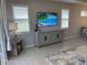 Comfortable living room with a media console and large windows bringing in plenty of light at 953 Crosswind Ave, Sarasota, FL 34240