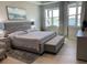 Serene main bedroom showcasing a plush bed, large windows, and a tranquil waterfront view at 953 Crosswind Ave, Sarasota, FL 34240