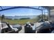 Outdoor patio overlooking a serene lake, featuring comfortable seating and scenic views at 953 Crosswind Ave, Sarasota, FL 34240