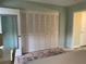 Bedroom featuring a carpet with colorful accent rug and wide closet with folding doors at 11201 80Th Ave # 305, Seminole, FL 33772