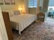 Comfortable bedroom with a large bed, colorful rug and desk by the window at 11201 80Th Ave # 305, Seminole, FL 33772