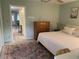 Bright bedroom featuring a large bed, dresser, ceiling fan and colorful accent rug at 11201 80Th Ave # 305, Seminole, FL 33772