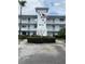 Charming condo with manicured landscaping, featuring a prominent building number and an American flag at 11201 80Th Ave # 305, Seminole, FL 33772