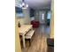 Bright dining area with a white table, views into the living room and modern flooring at 11201 80Th Ave # 305, Seminole, FL 33772