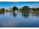 A beautiful pond surrounded by mature trees and condominium buildings at 11201 80Th Ave # 305, Seminole, FL 33772