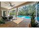 Outdoor dining area beside a screened in pool, complete with comfortable seating and greenery at 12117 Clear Harbor Dr, Tampa, FL 33626