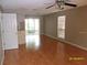 Spacious living room features wood floors, natural light and modern ceiling fan at 132 Douglas W Rd # B, Oldsmar, FL 34677